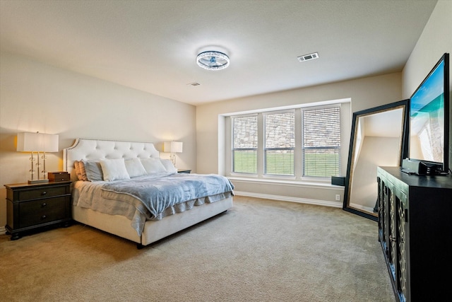 bedroom with light colored carpet