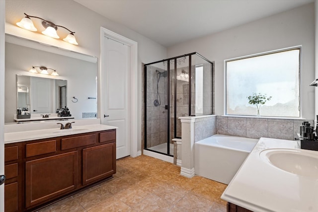 bathroom featuring vanity and independent shower and bath