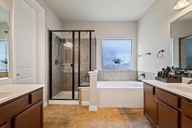 bathroom with vanity and separate shower and tub