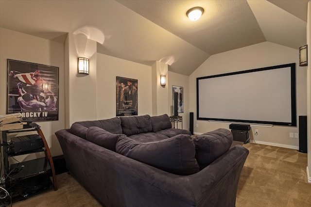 carpeted cinema room with vaulted ceiling