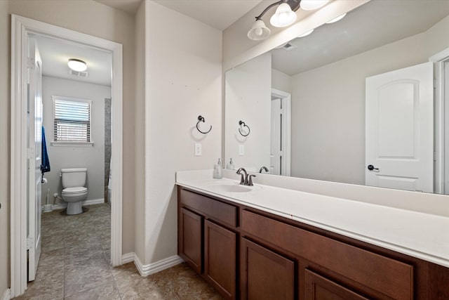 bathroom with toilet and vanity