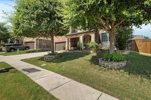 view of front of home with a garage and a front lawn