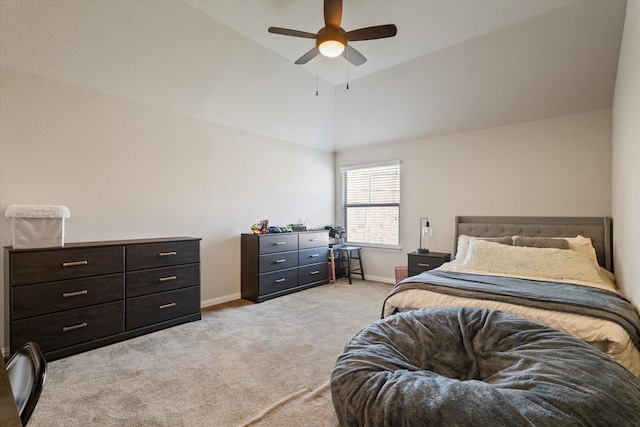 bedroom featuring ceiling fan, light colored carpet, and vaulted ceiling