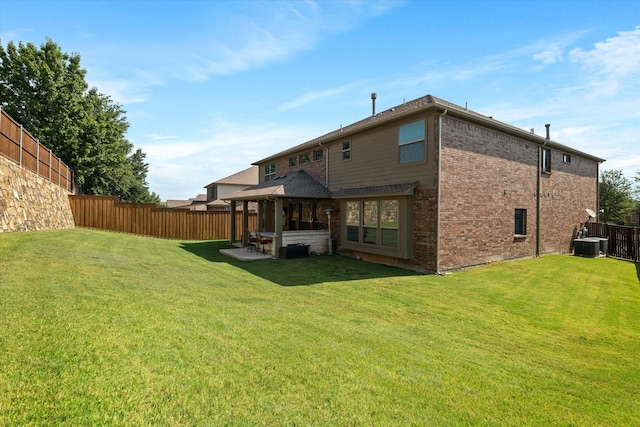 back of house featuring a lawn and central AC