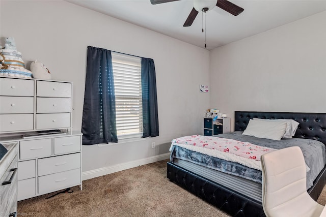 bedroom featuring ceiling fan, multiple windows, and carpet flooring