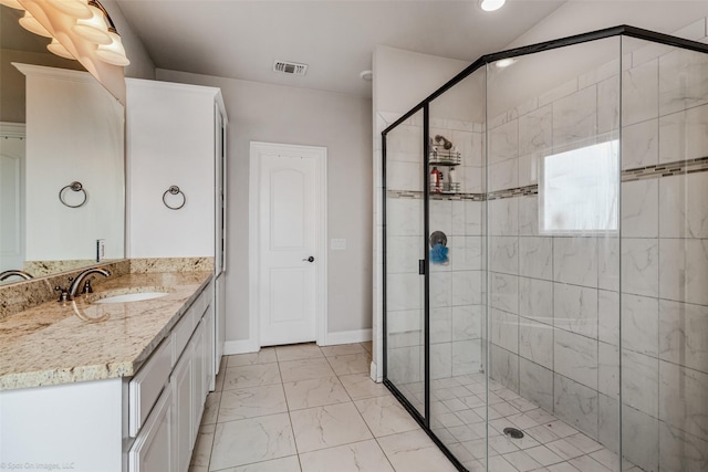 bathroom with walk in shower and vanity