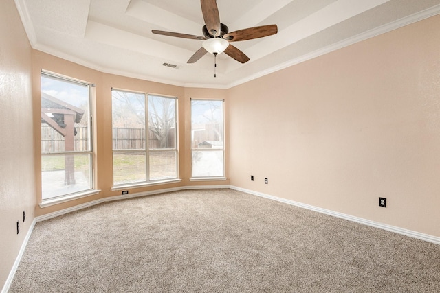 unfurnished room with crown molding, ceiling fan, a raised ceiling, and carpet