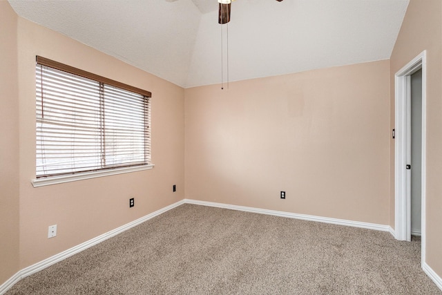 spare room with ceiling fan, lofted ceiling, and carpet