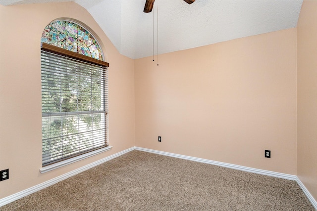 spare room featuring vaulted ceiling, ceiling fan, and carpet