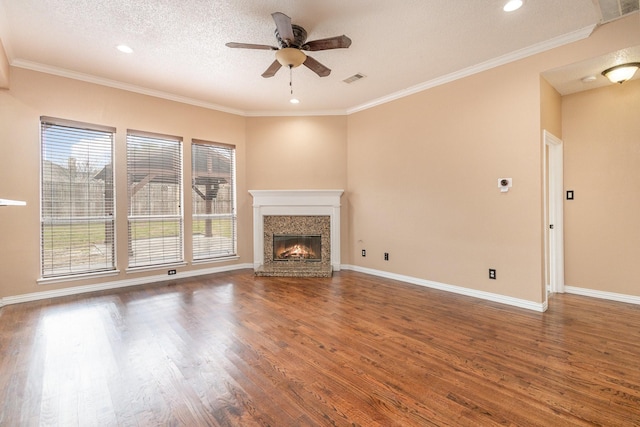 unfurnished living room with ceiling fan, crown molding, dark hardwood / wood-style floors, and a textured ceiling