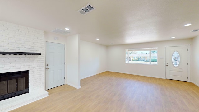 unfurnished living room with light hardwood / wood-style floors and a fireplace