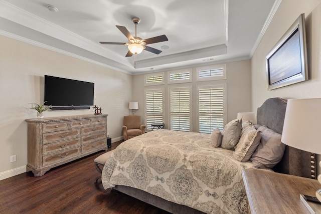 bedroom featuring ceiling fan, crown molding, dark hardwood / wood-style flooring, and a tray ceiling