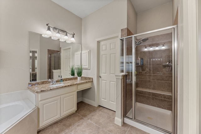 bathroom featuring plus walk in shower, tile patterned flooring, and vanity