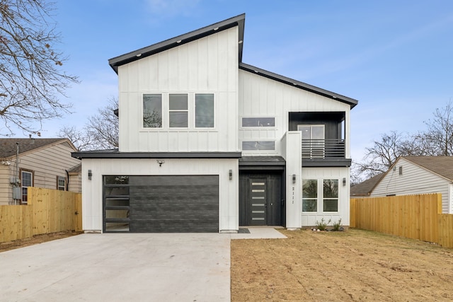 view of front of property featuring a garage and a balcony