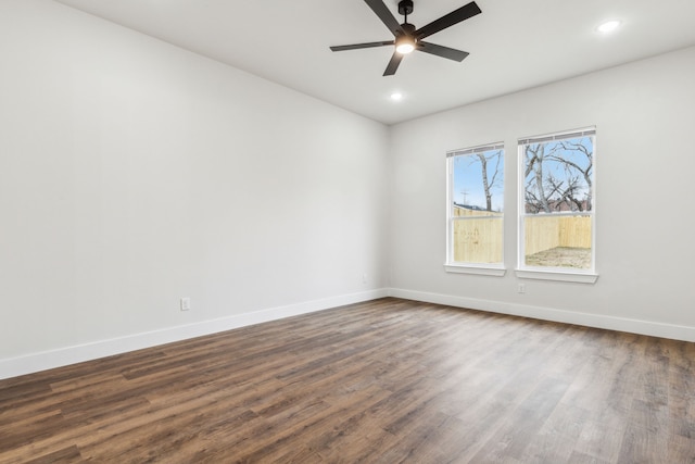 empty room with ceiling fan and dark hardwood / wood-style floors