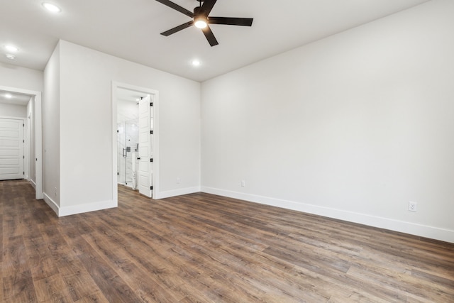 spare room with ceiling fan and dark wood-type flooring