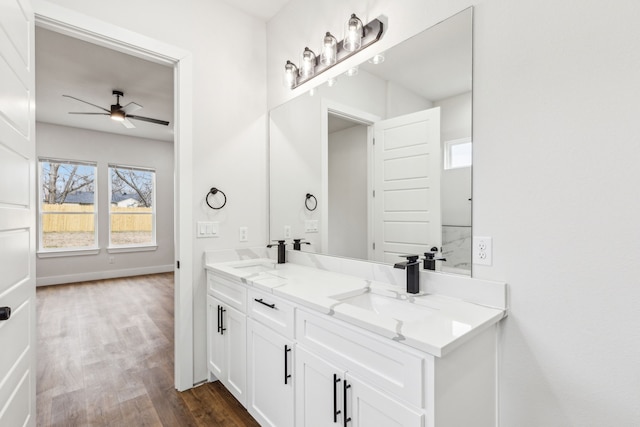 bathroom featuring ceiling fan, hardwood / wood-style floors, and vanity