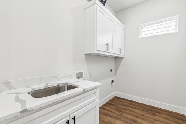 clothes washing area featuring sink, dark wood-type flooring, hookup for a washing machine, electric dryer hookup, and cabinets