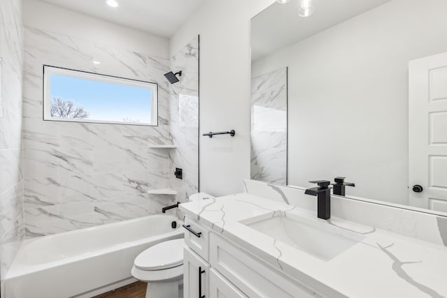 full bathroom featuring vanity, toilet, tiled shower / bath, and hardwood / wood-style flooring