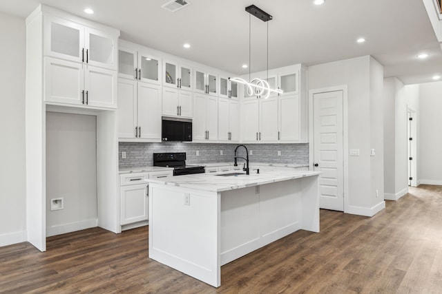 kitchen featuring a center island with sink, light stone countertops, black appliances, white cabinets, and sink