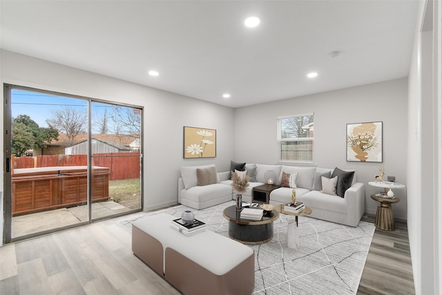 living area featuring baseboards, wood finished floors, and recessed lighting