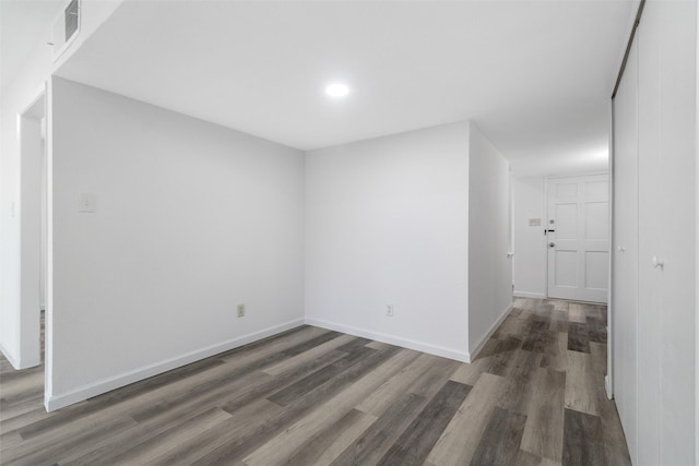 unfurnished room featuring dark wood-type flooring