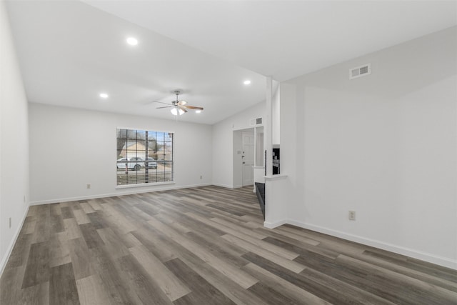 unfurnished living room with ceiling fan, hardwood / wood-style floors, and vaulted ceiling