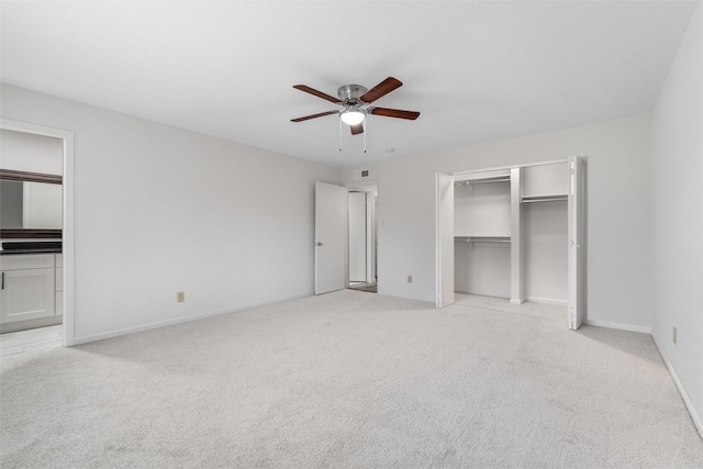 unfurnished bedroom with ceiling fan and light colored carpet