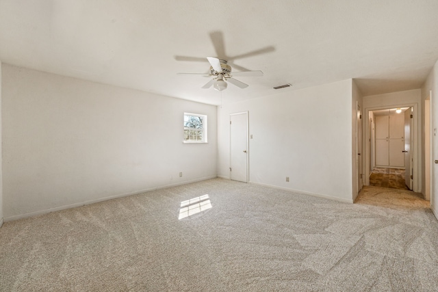 carpeted spare room with ceiling fan