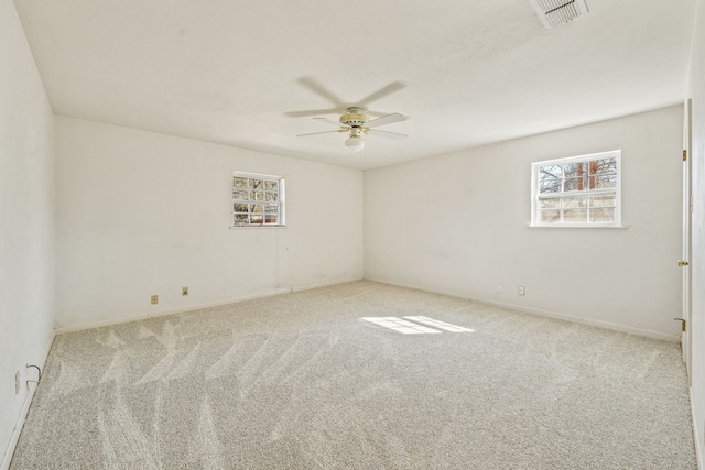 spare room featuring ceiling fan and light carpet