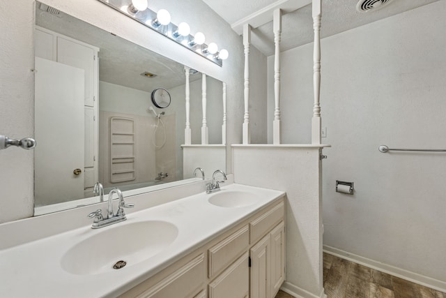 bathroom featuring shower / bath combination, a textured ceiling, and vanity