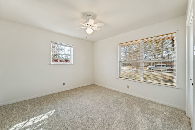 carpeted empty room featuring ceiling fan