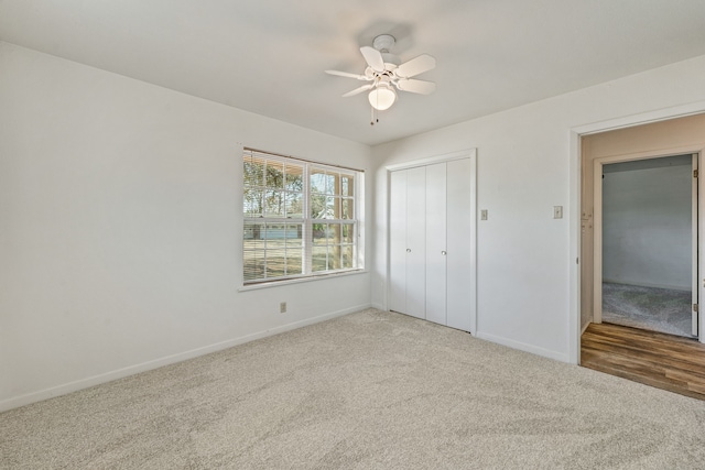 unfurnished bedroom featuring carpet, a closet, and ceiling fan