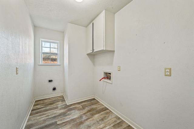 laundry room featuring hardwood / wood-style flooring, electric dryer hookup, cabinets, and washer hookup