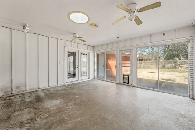 interior space featuring concrete floors, a textured ceiling, and ceiling fan