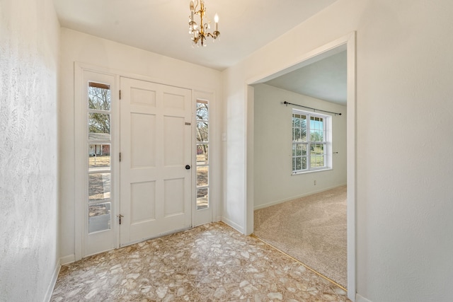 entryway featuring a chandelier and light colored carpet