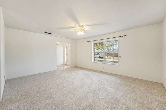 carpeted spare room with ceiling fan