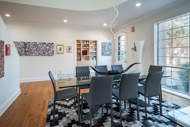 dining room featuring ornamental molding and hardwood / wood-style floors