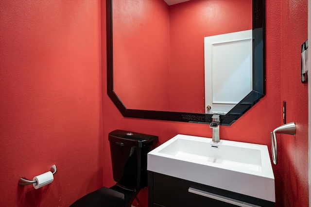 bathroom with toilet and vanity