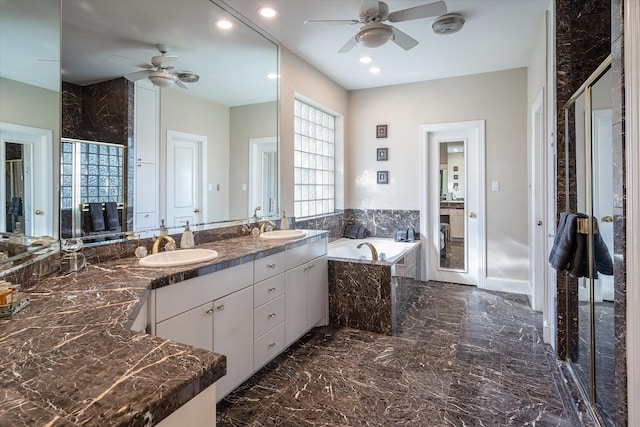 bathroom with vanity, ceiling fan, and tiled bath