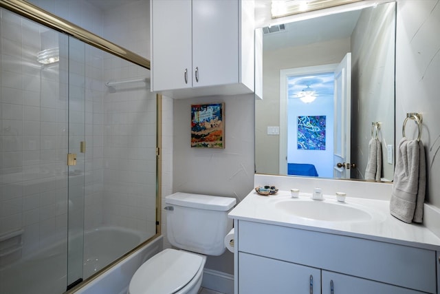 full bathroom with combined bath / shower with glass door, toilet, and vanity