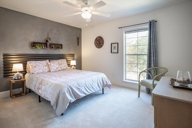 bedroom featuring ceiling fan and light carpet