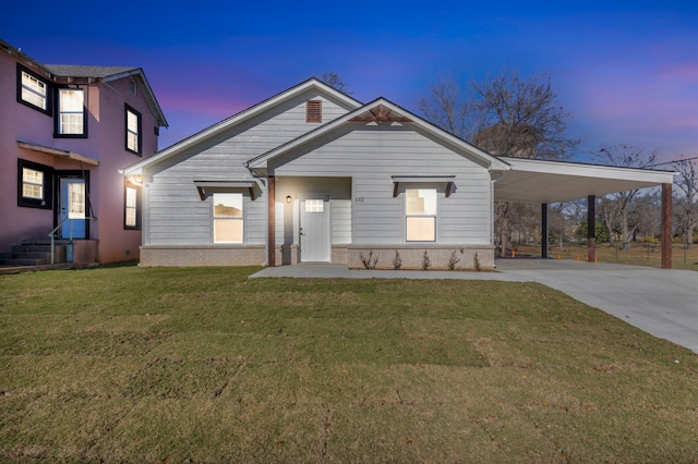 view of front of home with a lawn and a carport