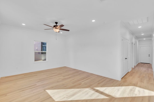 empty room with ornamental molding, ceiling fan, and light hardwood / wood-style flooring