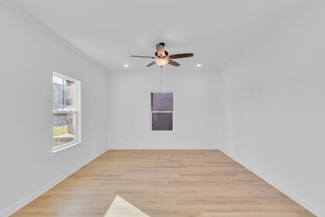 empty room with light wood-type flooring, ceiling fan, and ornamental molding