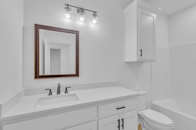 bathroom featuring toilet and vanity