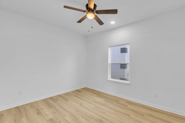 spare room featuring light hardwood / wood-style floors and ceiling fan