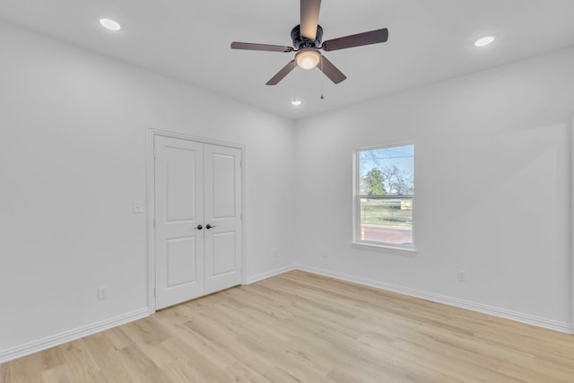 unfurnished room with light wood-type flooring and ceiling fan