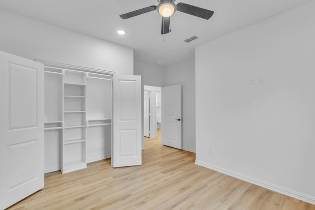 unfurnished bedroom with ceiling fan, a closet, and light wood-type flooring