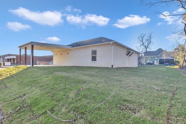 back of property featuring a lawn